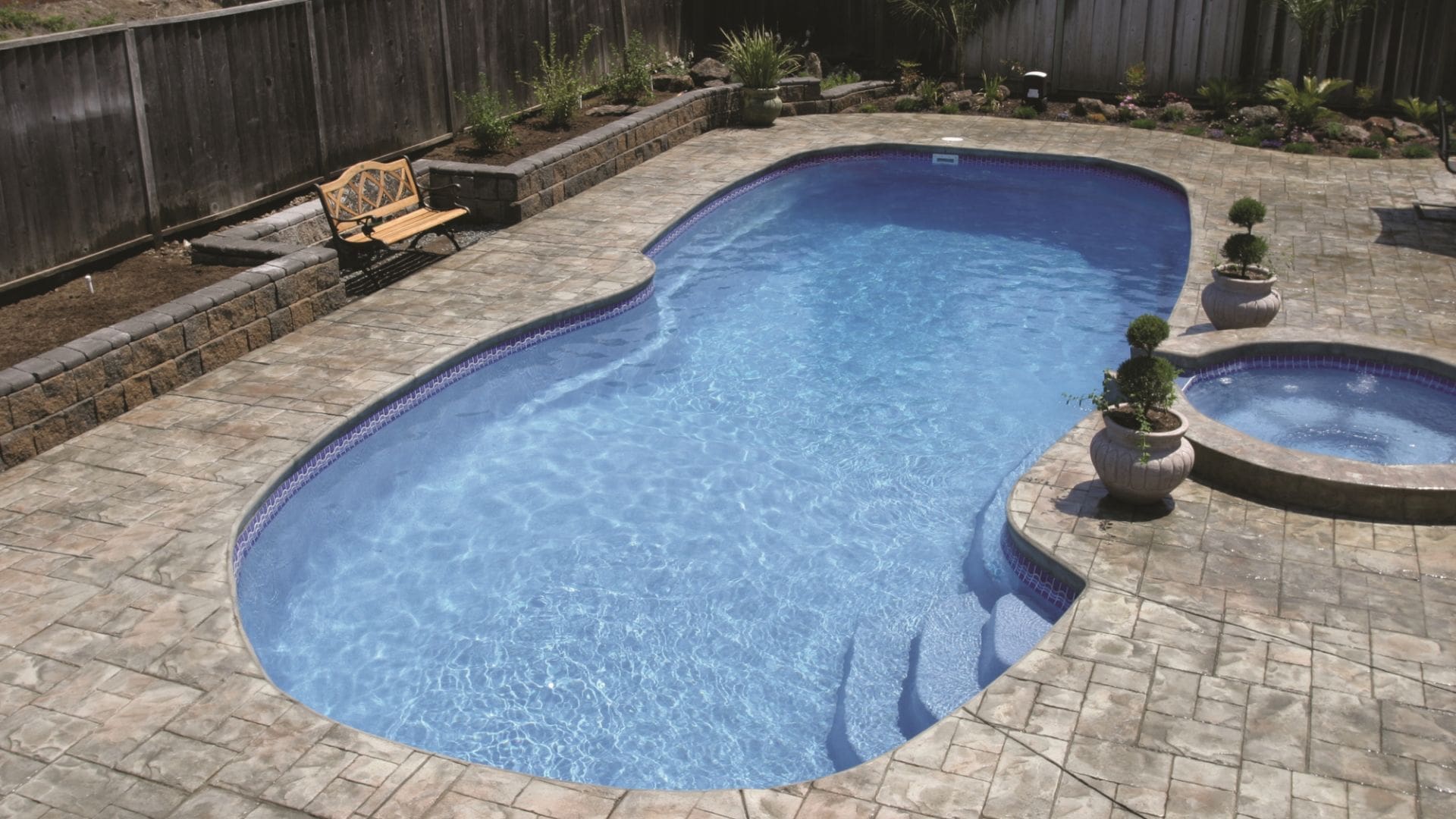 A freeform fiberglass pool