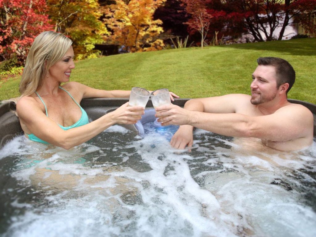 A couple using a hot tub for date night